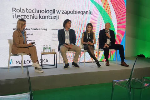 Czworo panelistów na scenie podczas sesji „Rola technologii w zapobieganiu i leczeniu kontuzji”.