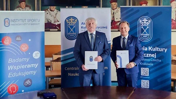 Dyrektor IS-PIB dr Jerzy Eliasz i Rektor AKF w Krakowie prof. dr hab. Andrzej Klimek prezentują teczki z podpisanym porozumieniem o współpracy.