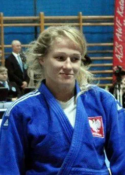 Dżudoczka Anna Borowska w niebieskim kimonie z godłem Polski.